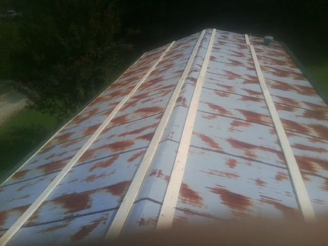 Rusted metal roof panels with new wood purlins before replacement — Storm Damage Roof Repair in Mogadore by Roofing Brothers