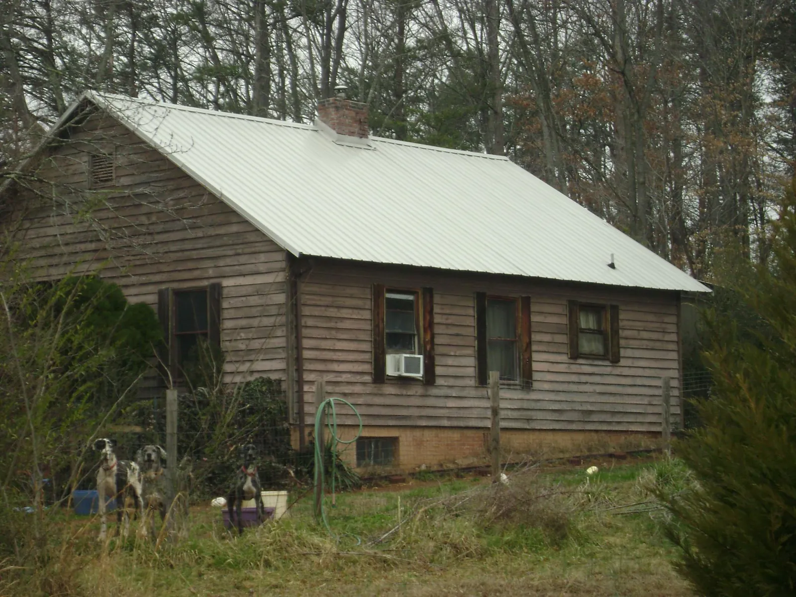 White metal roof on an old wood sided farmhouse, from a Metal Roof Installation job in Mogadore